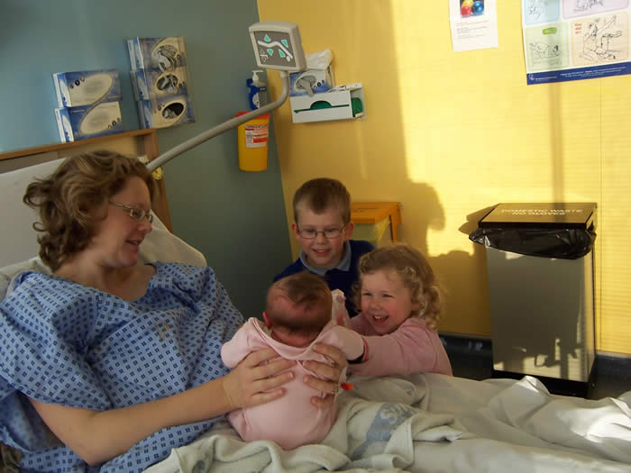 Cara's face is a picture - delighted to see her new sister!